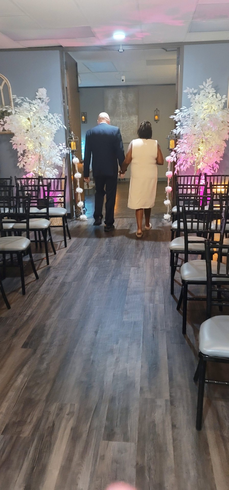 Couple walking down the chapel aisle
