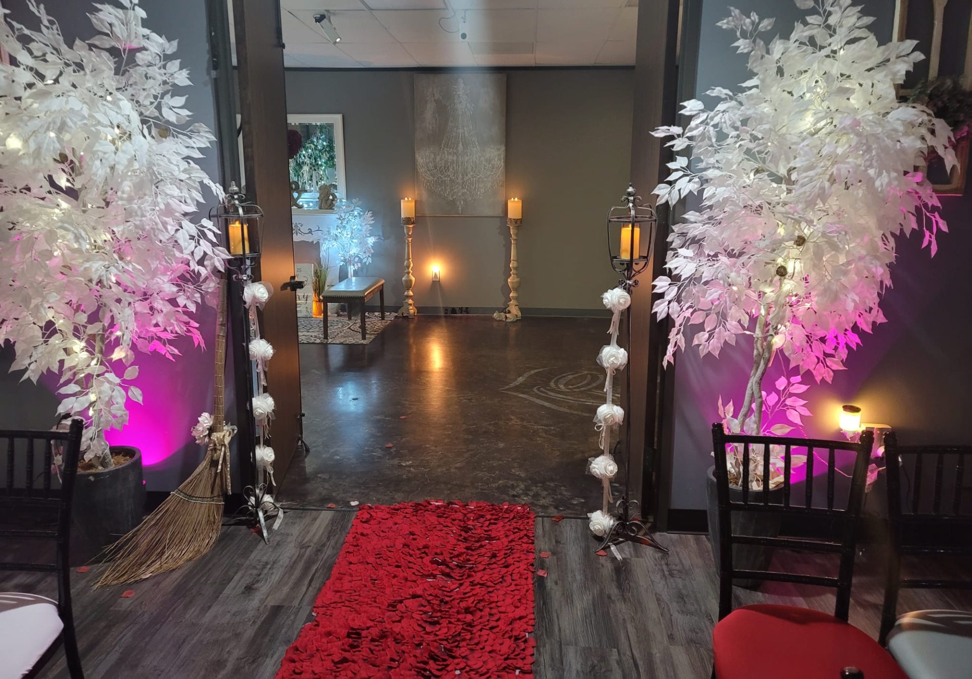 Chapel aisle with ambient candlelight and white trees